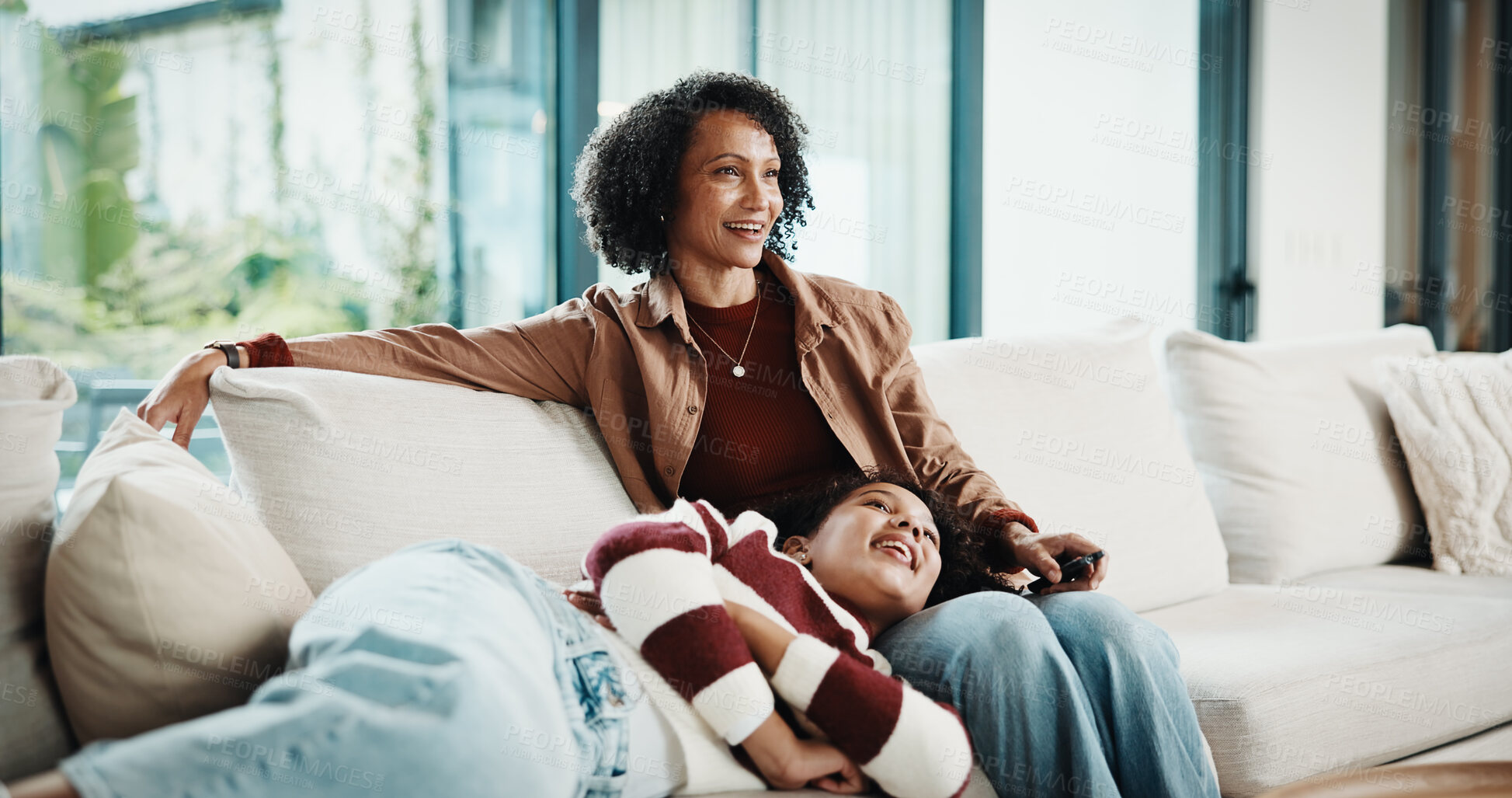 Buy stock photo Mom, child and happy with watching tv on sofa, remote and bonding with movie choice in living room. People, mother and daughter with streaming services, laugh and comedy film on couch at family house