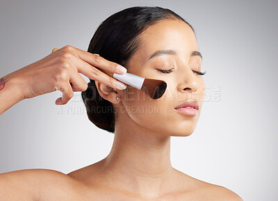 Buy stock photo Woman, brush and makeup application in studio with foundation, facial product and beauty routine. Female person, apply powder and cosmetics with tools, self care and grooming on white background.