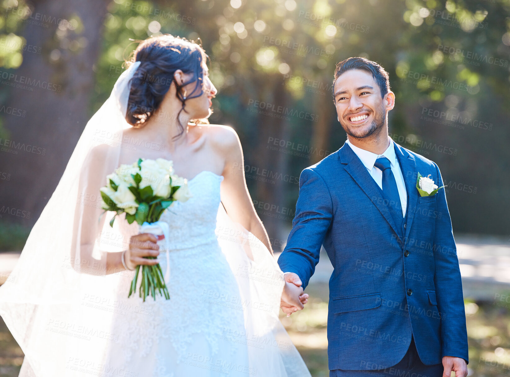 Buy stock photo Happy couple, wedding and holding hands at park with flowers for celebration, walk and care in spring. People, marriage and smile with bouquet, connection or love for relationship milestone at garden