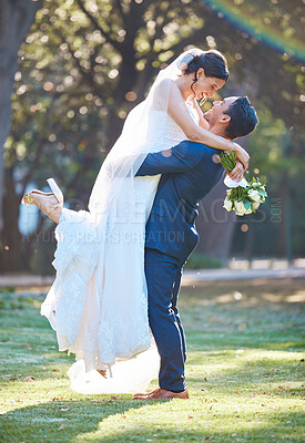 Buy stock photo Couple, wedding and lift with hug at park for celebration, excited and profile with bouquet in spring. People, marriage and happy with commitment, flowers or love for relationship milestone in garden
