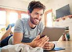 One fit young caucasian man using a digital tablet device while taking a break from exercise at home. Guy using fitness apps, browsing social media and watching online workout tutorials