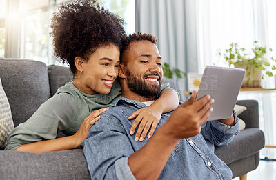 Buy stock photo Black couple, relax and hug with tablet at house for social media, browsing website and bonding. People, embrace and digital for streaming video, download movies and subscription for weekend break