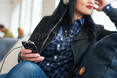 Buy stock photo Cellphone, relax and woman in office with music, radio or playlist on mobile app for streaming. Career, audio tech and female designer with phone for listening to album online at startup agency.