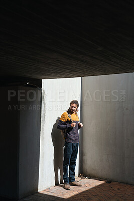 Buy stock photo Backpack, student and thinking with man on campus for education at college or university. Concrete, future and learning with person outdoor at school for development, scholarship study or vision