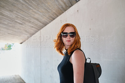 Buy stock photo Backpack, student and sunglasses with woman on campus for education at college or university. Concrete, academic and shades with person outdoor at school for development, scholarship or vision