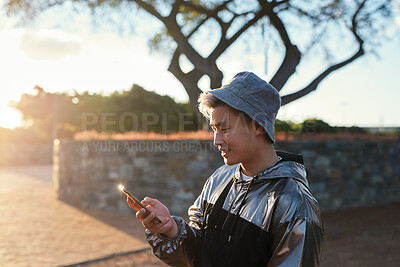 Buy stock photo Smile, man and student with phone at park for communication, social media and reading blog. Happy, asian person and tech on study break, university results and application with scholarship guide