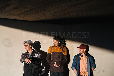 Buy stock photo Laughing, student and thinking with men on campus for fashion at college or university. Concrete wall, funny and future with friends outdoor at school for clothes style, scholarship or vision