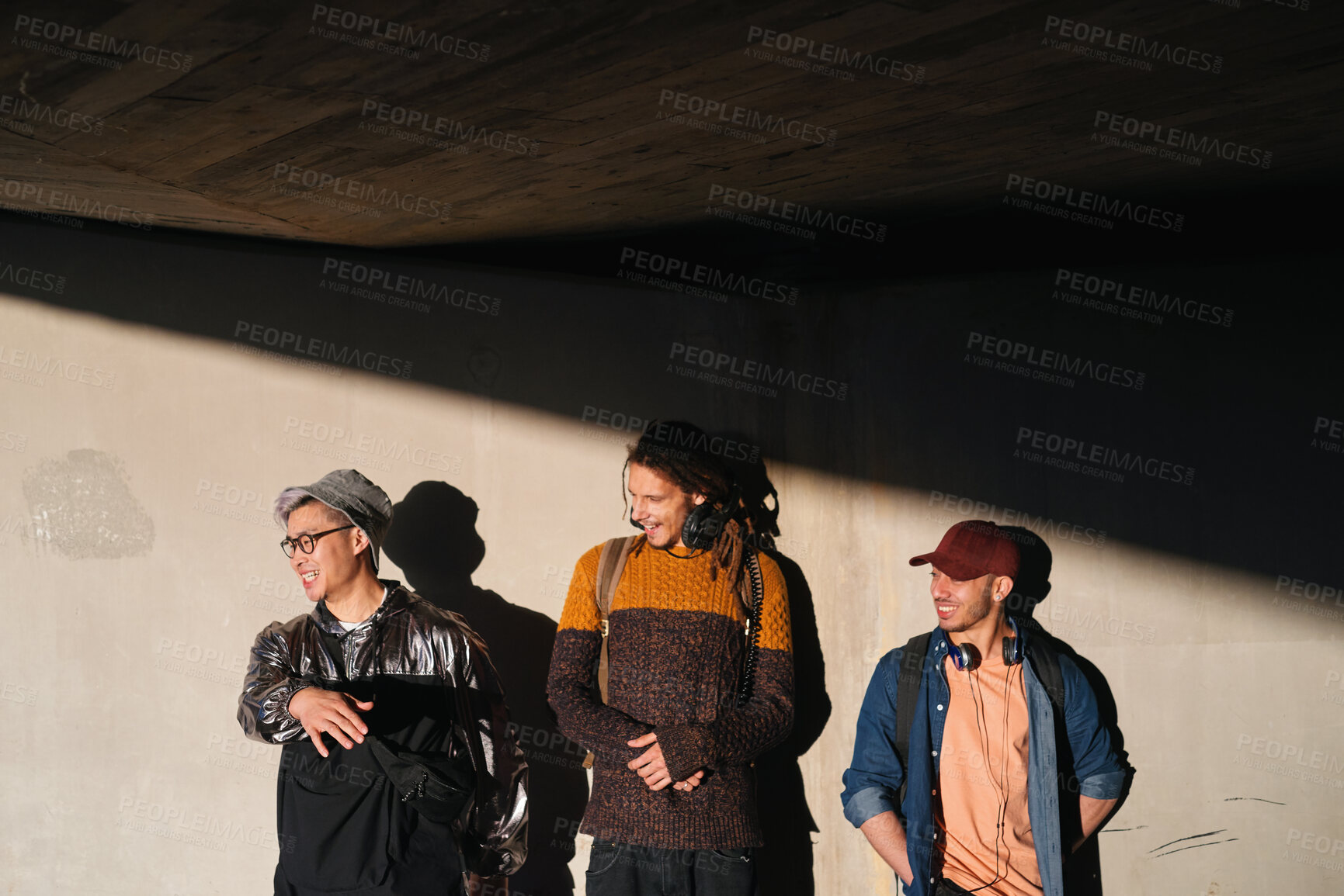 Buy stock photo Laughing, student and thinking with men on campus for fashion at college or university. Concrete wall, funny and future with friends outdoor at school for clothes style, scholarship or vision