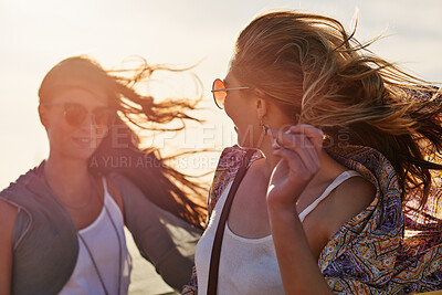 Buy stock photo Beach, sunglasses and wind with girl friends outdoor together for bonding, vacation or weekend. Breeze, holiday and sunset with women in shades on seashore in summer for break, getaway or travel