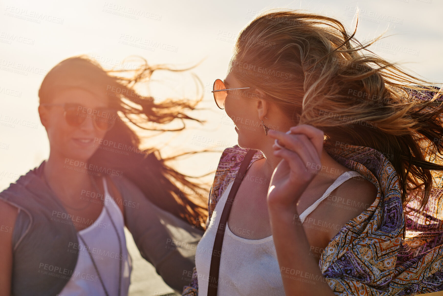 Buy stock photo Beach, sunglasses and wind with girl friends outdoor together for bonding, vacation or weekend. Breeze, holiday and sunset with women in shades on seashore in summer for break, getaway or travel