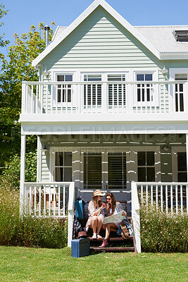 Buy stock photo Luggage, phone and map with women on porch together for holiday, travel or vacation. App, bags and search for directions with happy friends outdoor at guest house for sightseeing, tourism or trip