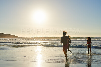 Buy stock photo Running, silhouette and friends on beach with holiday, travel adventure and tropical destination for sunset. Ocean, weekend trip and people with sunshine for island vacation, space or bonding in Bali