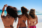 Three beautiful young women on vacation at the beach