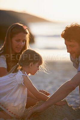 Buy stock photo Child, parents and sand castle on beach with people outdoor together for bonding or travel. Dad, daughter and mom with building activity on coast for coordination, development or growth as family