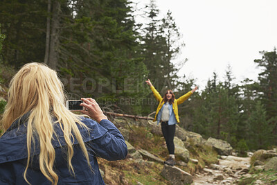 Buy stock photo Mountain, hiking and friends with photo in nature for adventure, travel and memory for holiday. Happy, phone and women with picture for social media, post and moment for tourism, explore and outdoor