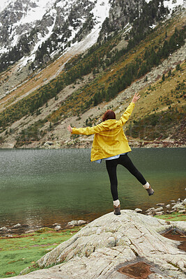 Buy stock photo Back, freedom and hiking with woman at lake in nature for adventure, journey or sightseeing. Arms raised, celebration and view with hiker person outdoor in mountains for activity, hobby or wellness
