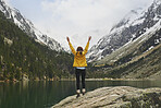 Travel adventure hiker woman celebrates on mountain lake arms outstretched enjoying beautiful nature landscape wanderlust