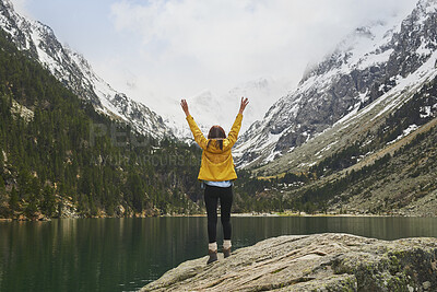 Buy stock photo Lake, mountains and person with back for celebration, success or hiking achievement. Travel, wellness or hiker in nature with arms up for winter journey, adventure or exploration by snow and water
