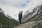 Travel adventure hiker woman on mountain lake enjoying beautiful nature landscape wanderlust