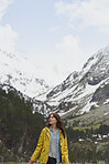 Adventure travel hiker woman exploring in beautiful green forest snow mountains on scenic outdoor tourist vacation
