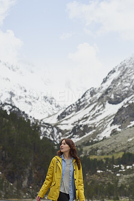 Buy stock photo Winter, woman and hiking in nature with mountain, snow or sightseeing exploration for outdoor adventure. Space, female person and peace in forest with scenic view, cold climate or travel for vacation