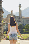 Travel woman looking at view of historical european town on adventure in Italy