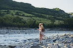 Adventure woman wearing vr headset augmented virtual reality in beautiful outdoor landscape concept