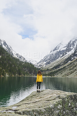 Buy stock photo Outdoor, mountain and woman by lake on holiday, getaway or weekend trip with sightseeing for exploration. Snow, travel and female person by river with scenic view, cold climate and peace on vacation.