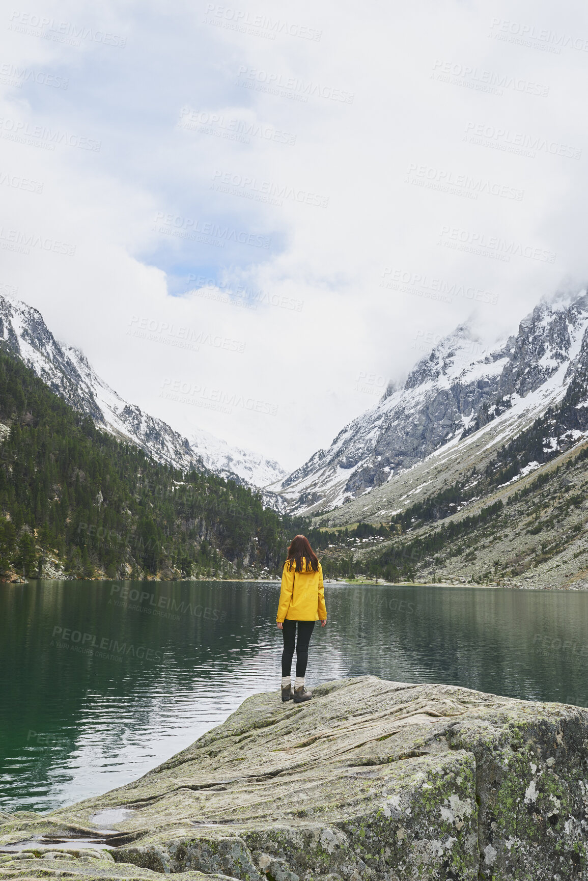 Buy stock photo Outdoor, mountain and woman by lake on holiday, getaway or weekend trip with sightseeing for exploration. Snow, travel and female person by river with scenic view, cold climate and peace on vacation.