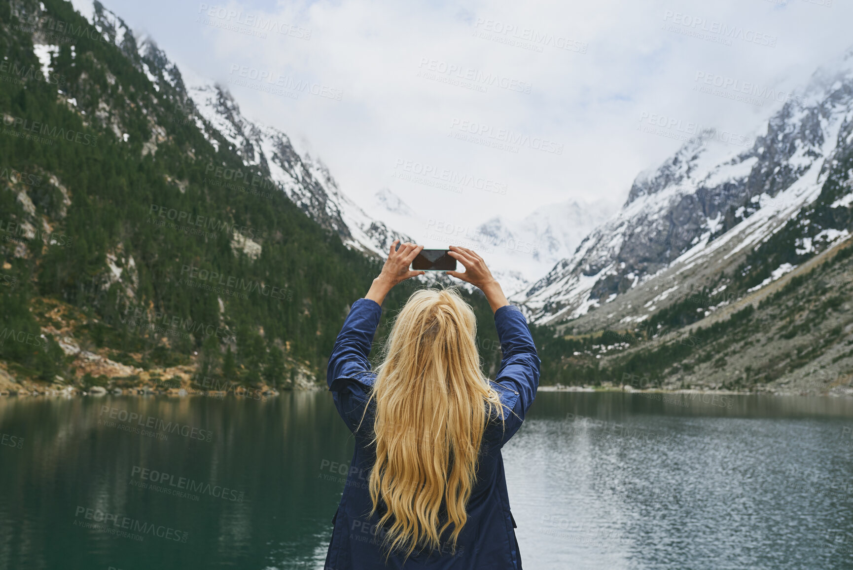 Buy stock photo Back, woman and hiking with phone for photography, social media post and travel blog. Space, person and mobile for profile picture update, trekking scenery and mountain view of wilderness trip