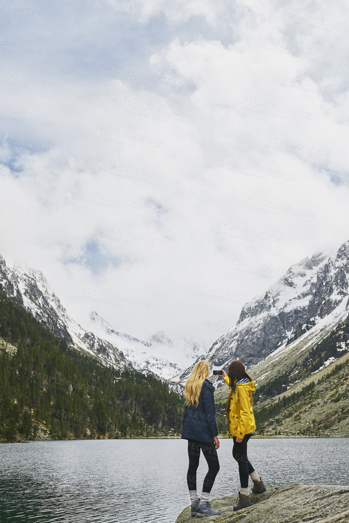 Buy stock photo Hiking, friends and women with selfie by lake on adventure, memory or connection by mountain. Trekking, back and people with picture for photography, social media post or travel together with space
