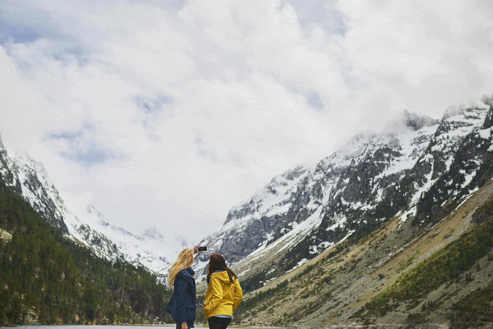 Buy stock photo Hiking, friends and women with selfie by mountain on adventure, memory or connection in nature. Trekking, back and people with picture for photography, social media post or travel together with space