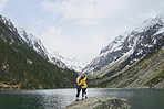 Travel adventure woman friends taking smart phone selfies on mountain lake enjoying beautiful nature landscape wanderlust