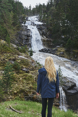 Buy stock photo Woman, hiking or sightseeing in forest with waterfall, exploration or outdoor adventure for winter trip. Back, female person and peace in nature with scenic view, cold climate or travel for vacation.