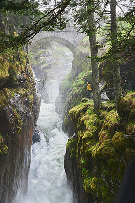 Buy stock photo Mountain, forest and woman by waterfall for nature, travel and outdoor adventure. Explore, discovery and person by river valley with woods, trees and jungle for environment, ecology or wilderness