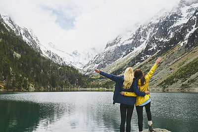 Buy stock photo Hiking, friends and freedom with mountain view in nature for adventure achievement by lake. Celebration, back and women outdoor for trekking success, arms raised or travel together with space