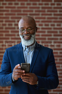 Buy stock photo Business, smile or black man by wall with phone, close deal or positive feedback in online chat. Happy, digital or mature property agent in office with tech, approval or good news on investment pitch