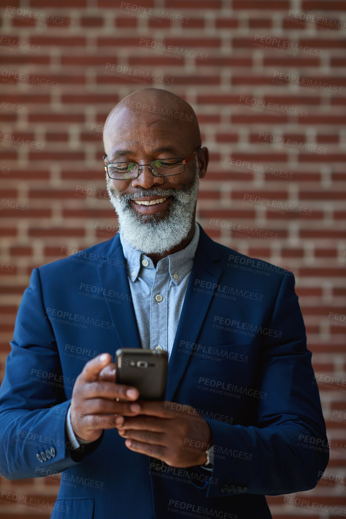 Buy stock photo Business, smile or black man by wall with phone, close deal or positive feedback in online chat. Happy, digital or mature property agent in office with tech, approval or good news on investment pitch