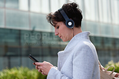 Buy stock photo City, phone and business woman with headphones, subscription service or browsing internet on commute. Mobile, employee and person outdoor with music for travel podcast, audio app or text message