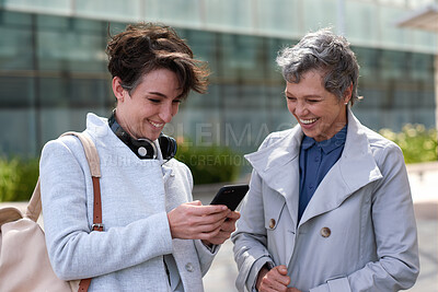 Buy stock photo Phone, smile and business women in city for social media, commute and morning communication online. Travel, conversation and friends with tech for laugh, humor or funny joke and networking or bonding