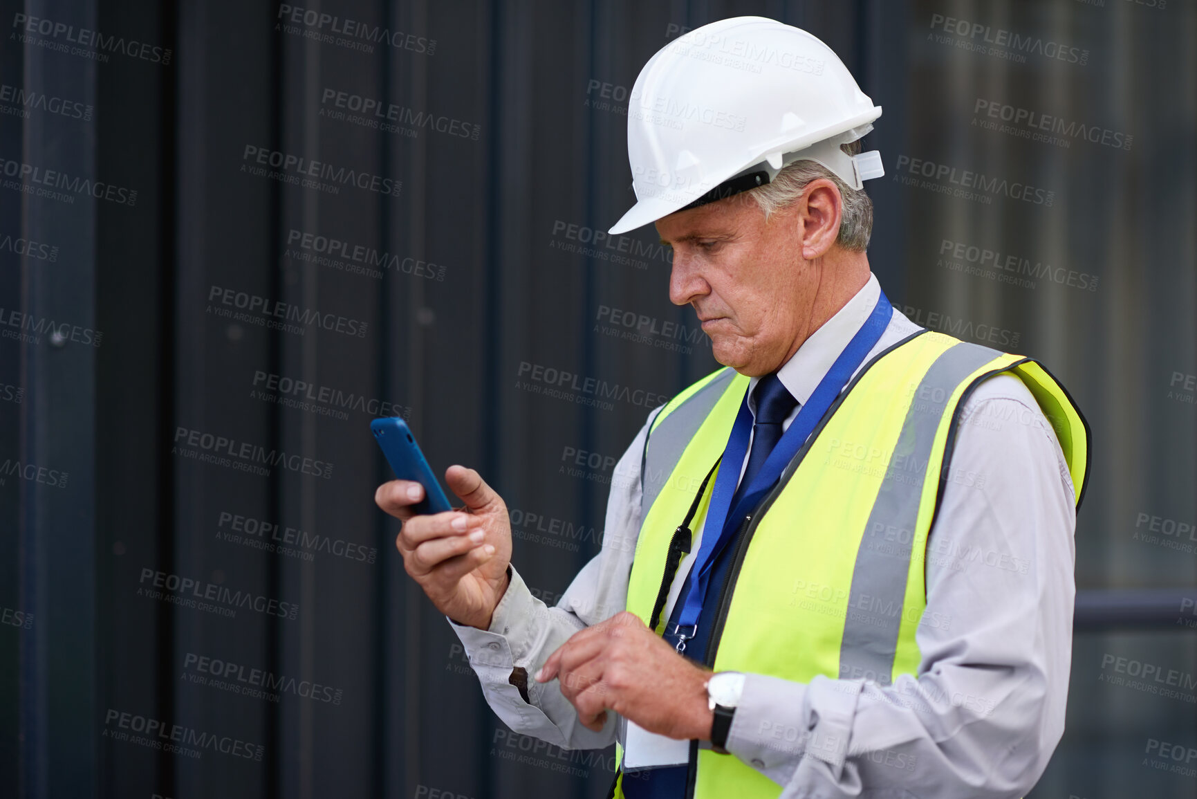 Buy stock photo Phone, man and construction manager on site with email for feedback on city maintenance or repairs. Cellphone, reading and mature male civil contractor with mobile app for review on building approval