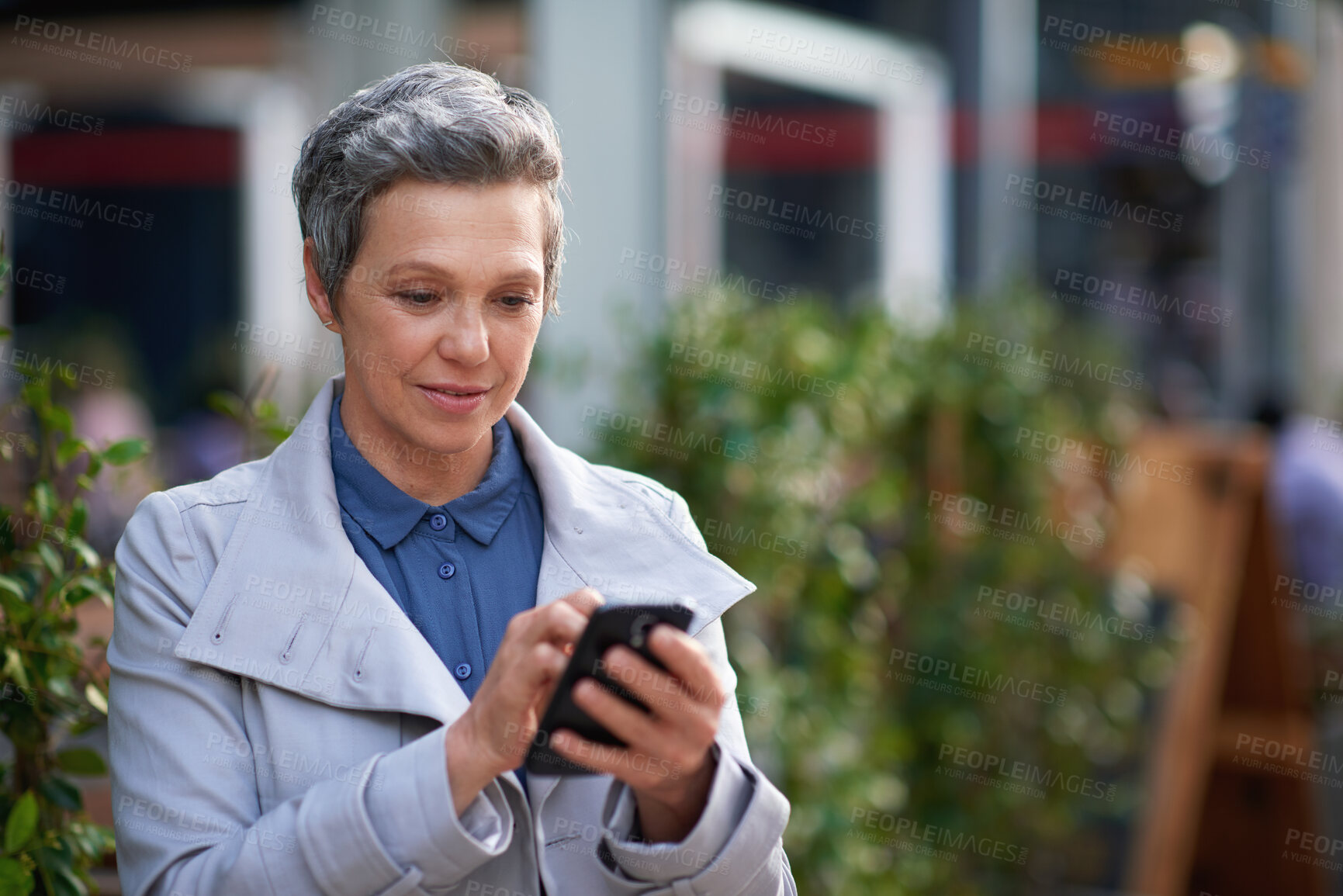 Buy stock photo Mature, phone and business woman in city for work commute, communication and travel with smile. Professional person, cellphone and texting or message to contact for feedback, network or outdoor