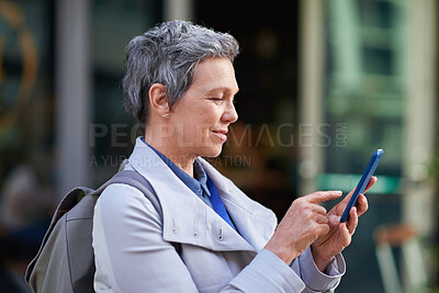 Buy stock photo Mature, phone and business woman outdoor for work commute, communication and network with smile. Professional person, cellphone and texting or message to contact for feedback, travel or city