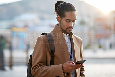 Buy stock photo Businessman, commute and typing in city with phone, text message notification and check social media. Person, scroll and browsing in urban town with tech, reading morning news and travel for work.