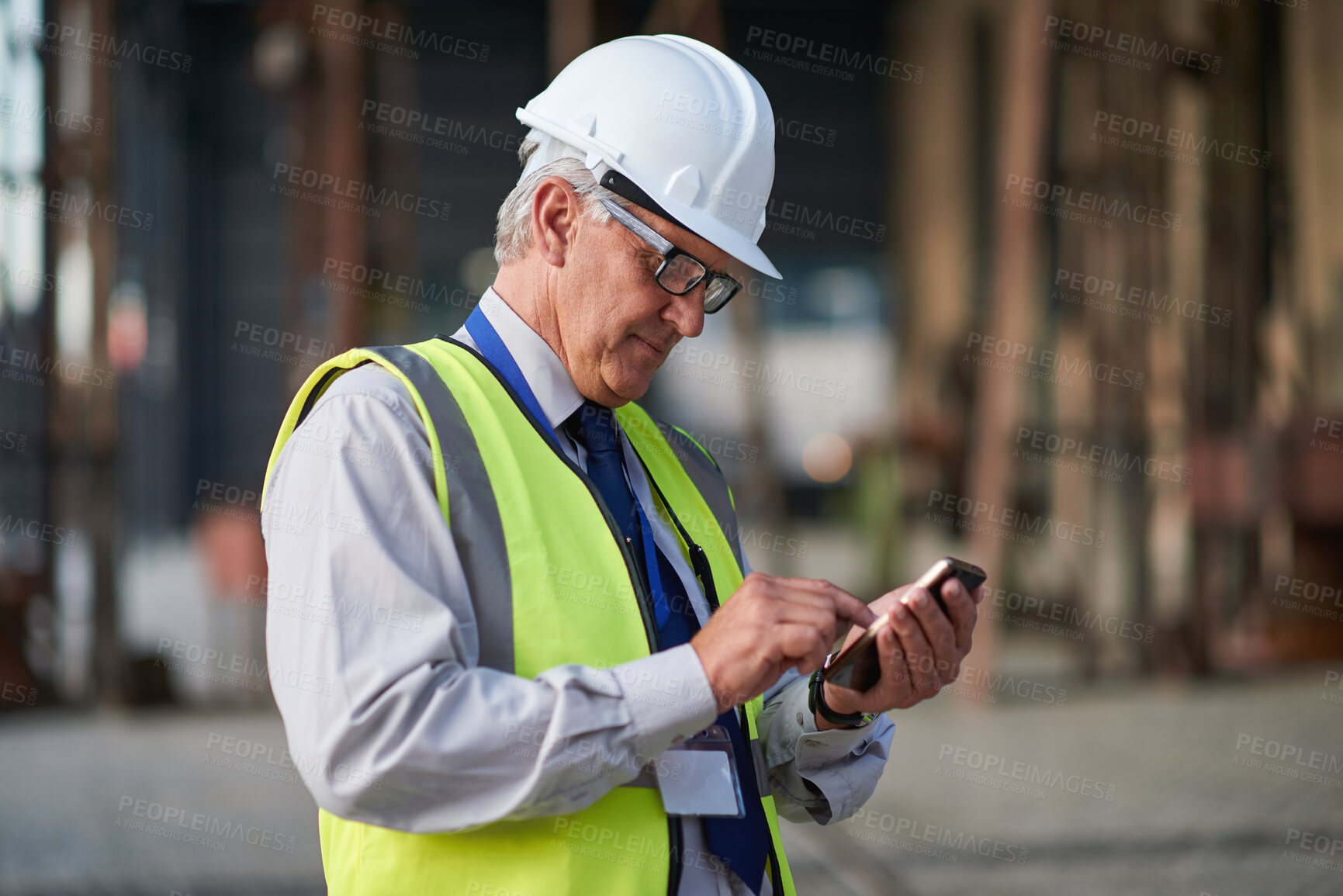 Buy stock photo Construction, phone and typing with mature man outdoor for project management or update. App, research and text message with contractor on building site for architecture, civil engineering or contact