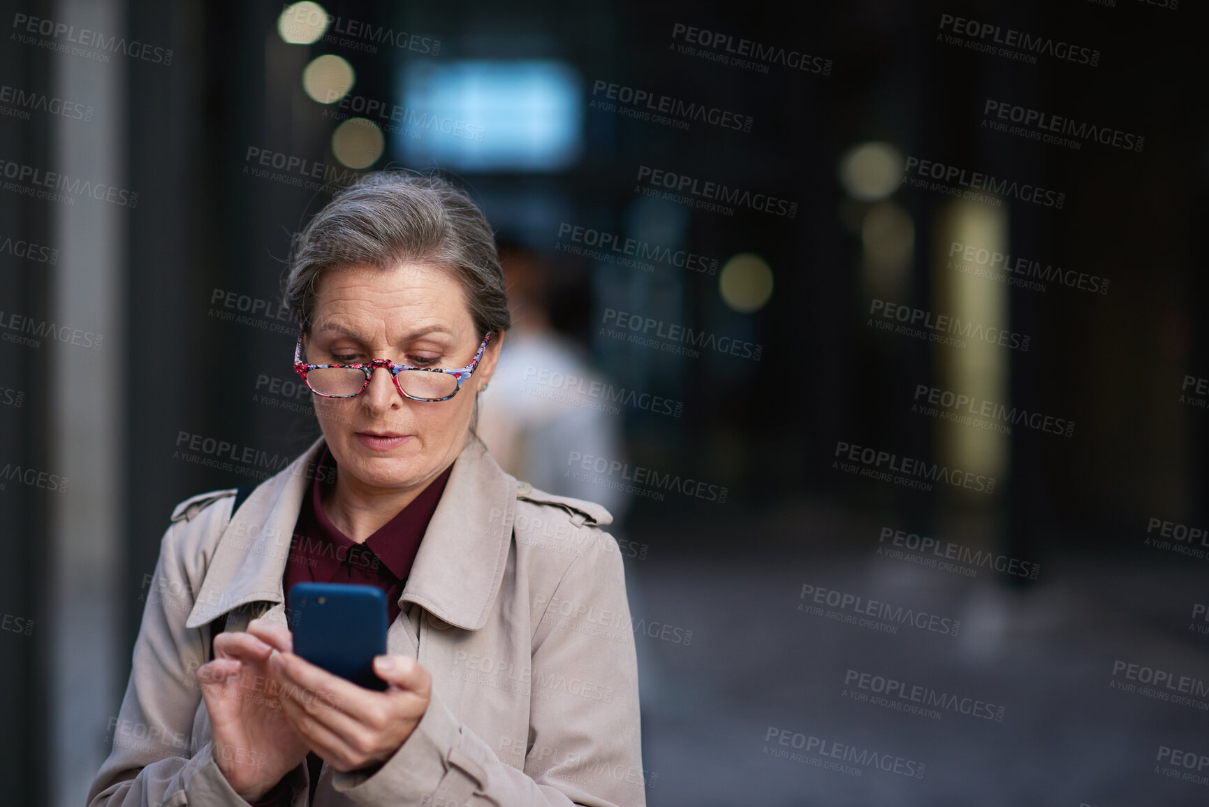 Buy stock photo Business, glasses and phone with woman at night for commute to work or search for directions. App, bokeh and space with mature employee in dark city for communication, route location or travel update
