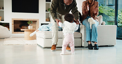 Buy stock photo Parents, baby or walking with help in living room, child development or support for motor skills. Father, applause or people with assistance for infant learning, home or first steps for bonding