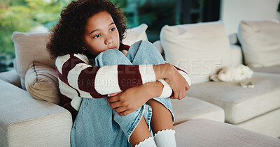 Buy stock photo Lonely, child and thinking on sofa, home and girl with low self esteem from bullying or bad memories. Remember, trauma and kid with anxiety, sadness and reflection on insecurity and mental health