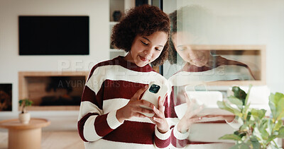 Buy stock photo Phone, smile and window with teen girl in home living room for social media or text message. App, reflection in glass and typing with kid in apartment for connection, internet browsing or search