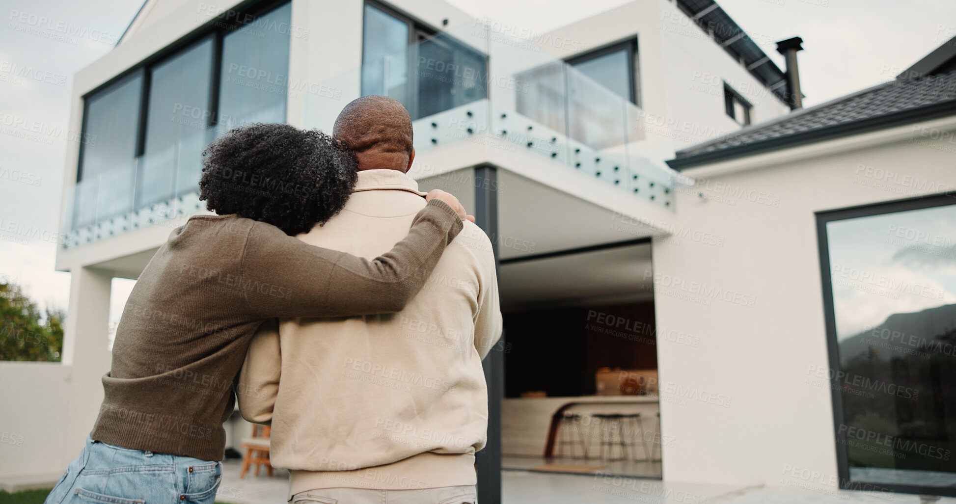 Buy stock photo Back view, couple and new home with hug outdoor, solidarity and support with property investment. Residence, real estate and homeowner people in relationship with growth, unity and house front lawn